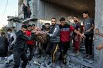 Men carry out the body of a victim from a building in Rafah in the southern of Gaza Strip as the Israeli bombardment continued Thursday.