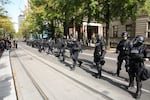 Police in riot gear respond to a protest outside Portland City Hall.