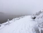Snow continues to pile up on a trail along the Willamette River.