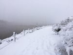 Snow continues to pile up on a trail along the Willamette River. 