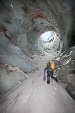 The spectacular "Cerberus Moulin" as it looked in November 2011. The moulin, or hole, dropped nearly 150 feet from the surface of the glacier to the floor of Pure Imagination cave. To enter and exit, the cave explorers used a complex system of ropes that were anchored into nothing more than snow and ice.