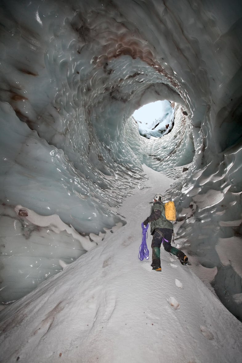 The spectacular "Cerberus Moulin" as it looked in November 2011. The moulin, or hole, dropped nearly 150 feet from the surface of the glacier to the floor of Pure Imagination cave. To enter and exit, the cave explorers used a complex system of ropes that were anchored into nothing more than snow and ice.