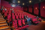 Moviegoers wait for their movie to start at the AMC Burbank in Burbank, Calif. on reopening day in March 2021.