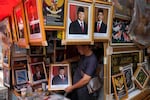 A vendor holds a portrait of Indonesian President-elect Prabowo Subianto at a market in Jakarta, Indonesia, April 24.