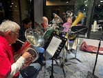 Pictured are two tubas and two euphoniums. They are just four tubas who joined us in studio to play a few pieces from Tuba Christmas. The quartet is composed of Chris Bolton, Heidi Aispuro, Dave Matthys and Charlie Violet.