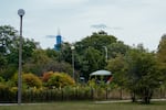 The Chicago skyline emerges behind an encampment in Humboldt Park.