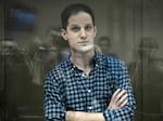 US journalist Evan Gershkovich, arrested on espionage charges, stands inside a defendants' cage before a hearing to consider an appeal on his arrest at the Moscow City Court in Moscow on Apr 18, 2023