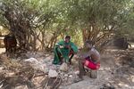 Paris's half-brother Ltesekwa stops to chat with a moran at a campsite near his own. During the dry season small groups of the boys spend months roaming into the mountains in search of pasture and water for their community's cattle.