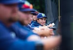 Pickles players lean against the dugout.