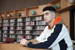 Max Decker, a senior at Lincoln High School, sits for a portrait in the school library where he often worked on writing his college essays, in Portland, Ore., Wednesday, March 20, 2024.