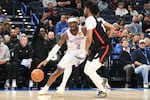 Oklahoma CIty Thunder guard Shai Gilgeous-Alexander, left, drives past Portand Trail Blazers guard Shaedon Sharpe, right, during the second half of an NBA basketball game, Wednesday, Nov. 20, 2024, in Oklahoma City.