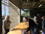 Local Ocean Seafoods owner Laura Anderson greets customers at her empty restaurant, which is now offering seafood meal kits for pick-up and delivery.