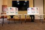 A voter casts his ballot at the South Branch Library during the presidential primary in Breckenridge, Colo., on March 5.