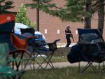 An armed law enforcment officer patrols the scene of the July 4th parade shooting in Highland Park, Illinois on Monday.