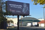 An attack ad billboard on Thursday, Oct. 8, 2026 along a busy street in Bend. Ore., has caused a stir in the race for Deschutes County Commissioner with candidate Rob Imhoff using images of opponent Morgan Schmidt at a 2020 protest against immigration arrests in the city.
