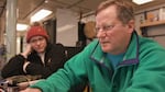 In this video still, Bill Chadwick (right), Oregon State University volcanologist and chief scientist on the research cruise on the RV Thompson in June 2022, works on a schedule for the multiple projects happening on board.