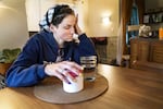 Shelby Boyd takes medication at her home in Lake Oswego in August. Boyd, who had COVID-19 in January 2021, is still enduring near-blackouts, brain fog and fatigue and is one of roughly 200,000 Oregonians who've developed long COVID-19.