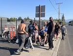 Homeless folks line up outside Parker's Place Village on Aug, 4, 2026, hoping to get one of the last 26 beds.