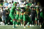 Oregon Ducks quarterback Dillon Gabriel (8) hands the ball off to Oregon Ducks running back Jordan James (20) during the first half of an NCAA college football game against Idaho, Saturday, Aug. 31, 2024, in Eugene, Ore.