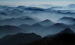 Craggy mountain peaks are blanketed in wildfire smoke in the Northern Cascade range near Mazama, Wash., Sept. 1, 2022.