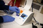 Medical technician Michelle Sitz analyzes a COVID-19 test in the Yellowhawk lab. The clinic uses a 15-minute PCR test to turn out results quickly.