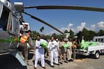 Security personnel load relief food bags into a government helicopter for people affected by floods in Saidu Sharif, in the Swat Valley, on Aug. 30. On Tuesday, the U.N. launched an appeal with the Pakistani government to raise $160 million in emergency aid.