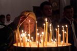 Parishioners light candles during the Paschal Liturgy at St. John the Baptist Ukrainian Orthodox Church in Portland.