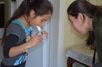 Adriana Perez, with the Yakima Valley Farm Workers' Clinic, administers a breathing test to 10-year-old Azul, who has poorly-controlled asthma.