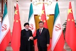 Iranian President Ebrahim Raisi (left) shakes hands with Chinese leader Xi Jinping in an official welcoming ceremony in Beijing, Feb. 14.