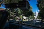The state Capitol building is seen through the windows of police officer Nicole Schmitgen's squad car during her patrol on Monday, July 18, 2022 in Madison, Wis.