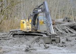 An excavator working in the debris field near Oso, Wash., where a mudslide destroyed a neighborhood in March. The death toll reached 28 as of April 2.