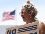An attendee of the rally yells and cheers with the crowd as a city representative speaks.