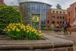 People walk across the University of Oregon campus on a rainy March day in 2015.