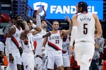 The bench celebrates a 3-point basket by Portland Trail Blazers guard Dalano Banton (5) during the second half of an NBA basketball game against the New Orleans Pelicans in New Orleans, Monday, Nov. 4, 2024.