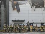 Firefighters gather at the site of a fire at a lithium battery factory owned by South Korean battery maker Aricell in Hwaseong, South Korea, on June 24.