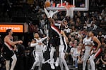 Portland Trail Blazers' Deandre Ayton (2) reaches for the ball during the second half of an NBA basketball game against the San Antonio Spurs, Thursday, Nov. 7, 2024, in San Antonio. San Antonio won 118-105. (AP Photo/Darren Abate)