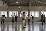 A military saber training session at Fort Vancouver National Historic Site. At front, Instructor-at-Arms Jeff Richardson of Academia Duellatoria is dressed in an 1850s U.S. Army Dragoon officer’s summer uniform. Trainees are conducting a solo drill of the cuts and guards from the Army’s sword fighting manuals of the time period.