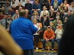 Community members listen to East Palestine Mayor Trent Conaway during a town hall meeting last week.