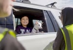 A young boy and his dog, Cosmo, are greeted by First Nations Veterinary volunteers in Warm Springs, Ore., on April 26, 2025.