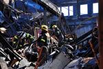 Investigators and crew with Hillsboro Fire and Rescue carefully search through debris at the site of fire downtown.