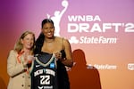 Oregon's Nyara Sabally, on the right, poses for a photo with WNBA commissioner Cathy Engelbert at the 2022 draft.