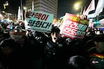 A man shouts to demand South Korean President Yoon Suk Yeol to step down in front of the National Assembly in Seoul, South Korea, Wednesday, Dec. 4, 2024.