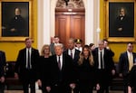 President-elect Donald Trump, front, and his wife Melania, walk with Majority Leader John Thune, R-S.D., and his wife, Kimberley, to meet with Senate Republican at the U.S. Capitol, Wednesday, Jan. 8, 2025, in Washington. (AP Photo/Steve Helber)