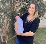 Amanda Harrison holds her baby, Lake, outside her mother's home in Phenix City, Ala., on Monday, Oct. 18, 2021. Harrison was put on a ventilator and later life support after becoming ill with COVID-19 in her third trimester of pregnancy. Doctors delivered Lake at 32 weeks and put Harrison on a type of life support called extracorporeal membrane oxygenation to save her. Harrison, who was unvaccinated, is urging pregnant women to get vaccinated for COVID-19. (AP Photo/Kim Chandler)