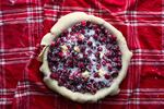 After the Cranberry Pie filling is dotted with butter, roll out the top dough and lay it over the fruit; then you can trim and finish with signature vents, appliqués, crimps, flutes – even lattice.