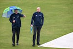 Field umpires Adrian Holdstock (L) and Michael Gough inspect the outfield after rain delayed the start of the ICC Champions Trophy one-day international (ODI) cricket match between Pakistan and Bangladesh at the Rawalpindi Cricket Stadium in Rawalpindi on February 27, 2025.