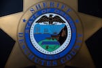 FILE - A Deschutes County sheriff's emblem outside the office in Bend, Ore., Dec. 10, 2021.