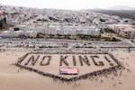 San Francisco: People form a human banner at Ocean Beach.