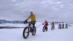 Steve Mitchell leads a group of fat bike cyclists on a early morning ride in the Methow Valley over the hard-crusted snow.