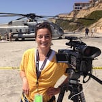 Flaccus in front of a disabled U.S. Marine helicopter that had made a safe crash landing on the beach in the San Diego, Calif., area, year unknown.